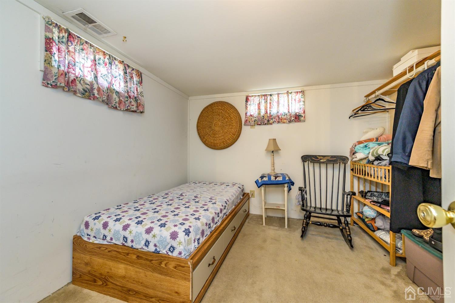 456 Dover Road Toms River, NJ 08757 - Photo 29 of 39 a bedroom with a bed and a chandelier
