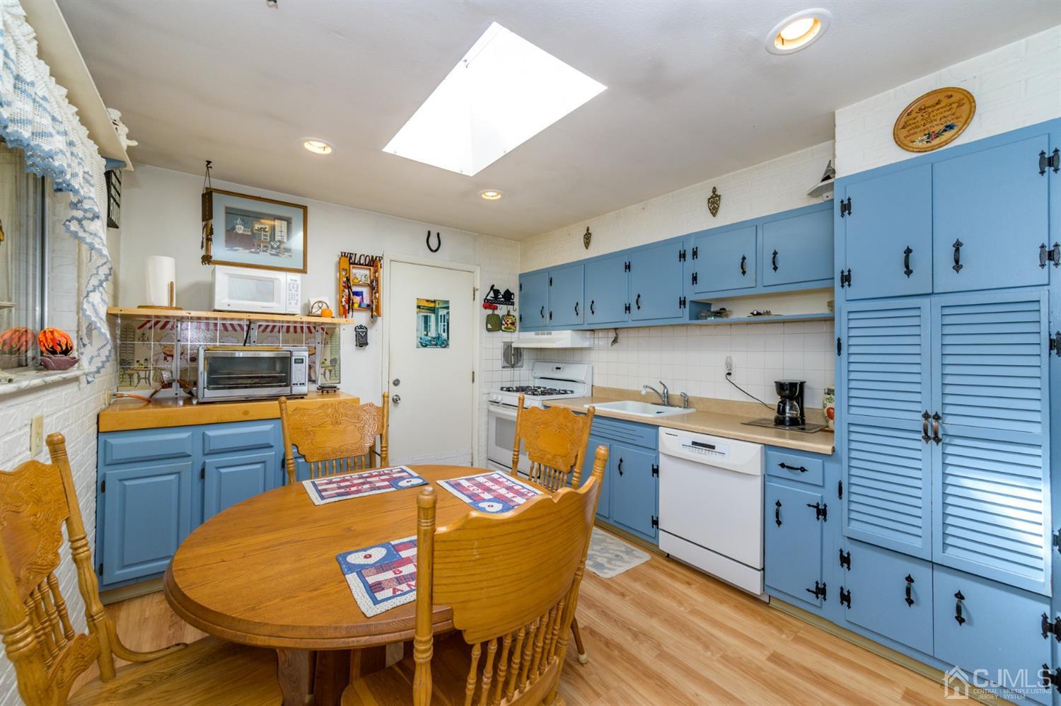 456 Dover Road Toms River, NJ 08757 - Photo 10 of 39 a kitchen with stainless steel appliances granite countertop a stove a sink dishwasher and cabinets with wooden floor