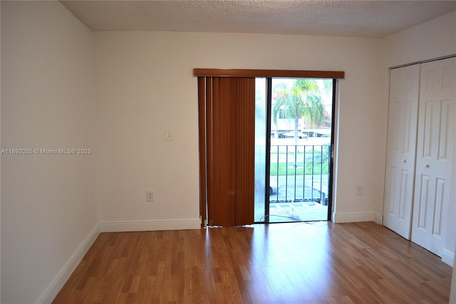6475 Southwest 129th Place, Unit 4094 Miami, FL 33183 - Photo 11 of 20 a view of an empty room with wooden floor and a window
