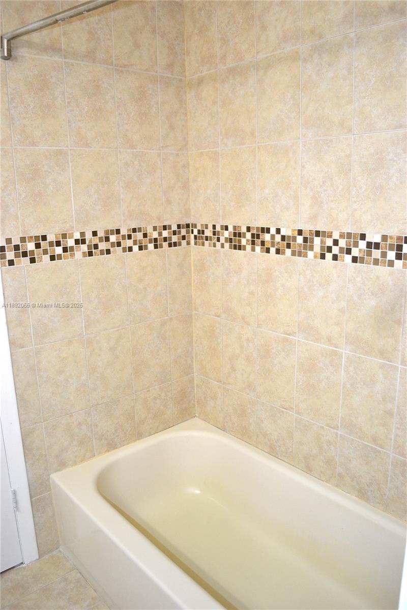 6475 Southwest 129th Place, Unit 4094 Miami, FL 33183 - Photo 16 of 20 a bathroom with a bathtub and shower