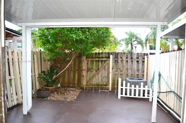 a view of an outdoor space with wooden floor and fence