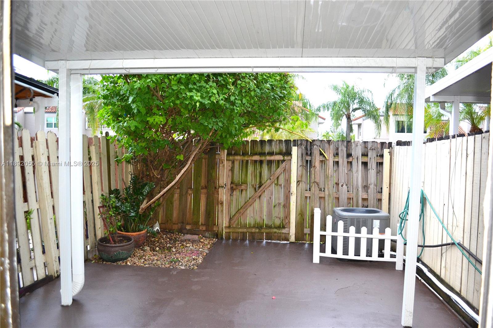 6475 Southwest 129th Place, Unit 4094 Miami, FL 33183 - Photo 18 of 20 a view of an outdoor space with wooden floor and fence