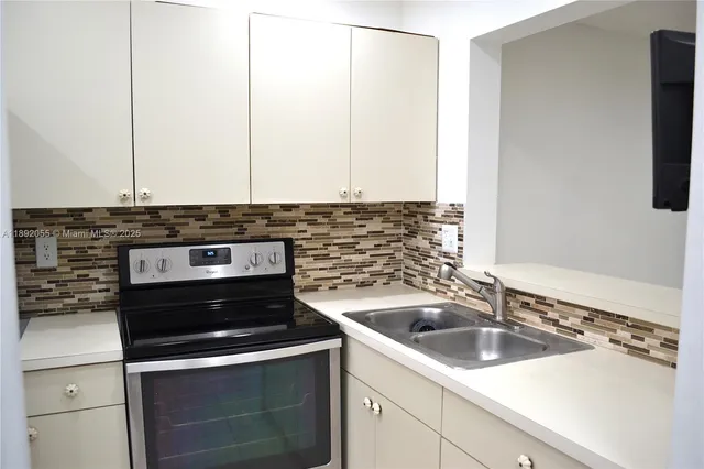 a kitchen with a sink and cabinets