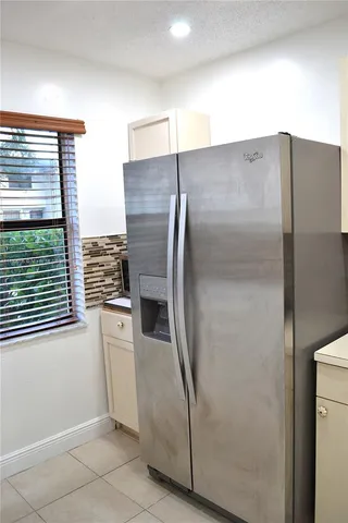 a metallic refrigerator freezer and a microwave