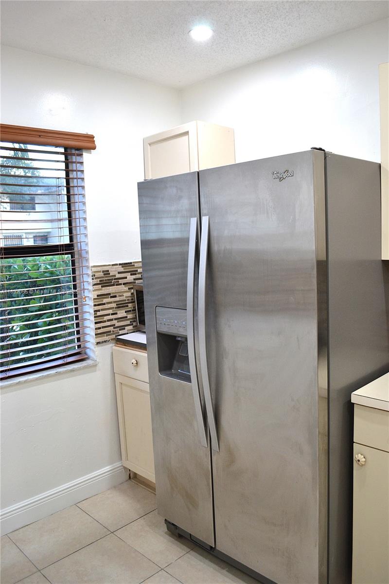 6475 Southwest 129th Place, Unit 4094 Miami, FL 33183 - Photo 10 of 20 a metallic refrigerator freezer and a microwave