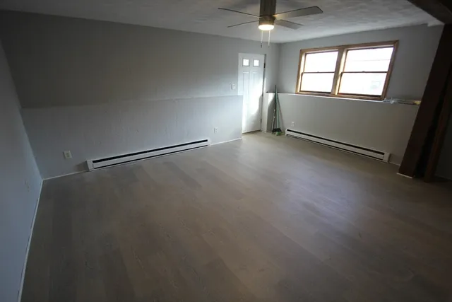 wooden floor in an empty room with a window
