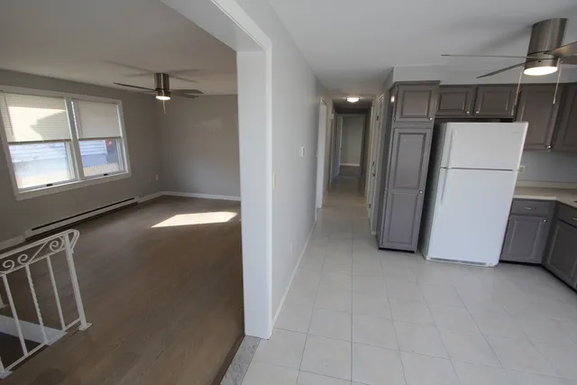 a view of an empty room with a fireplace