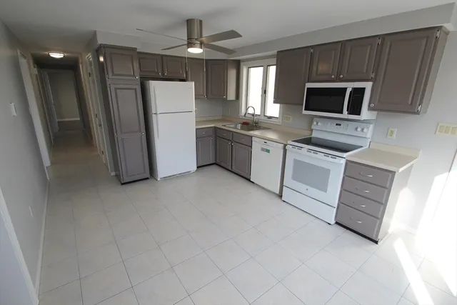 a kitchen with a refrigerator sink and microwave