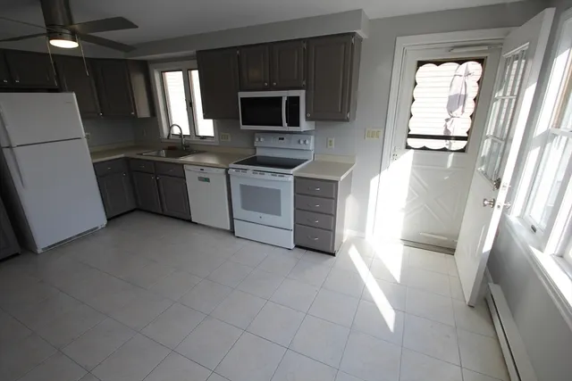 a kitchen with a refrigerator sink and microwave