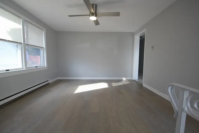wooden floor in an empty room with a window