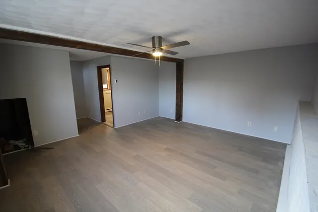 a view of an empty room with a fan