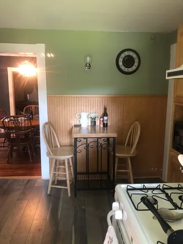 a dining room with furniture and a window