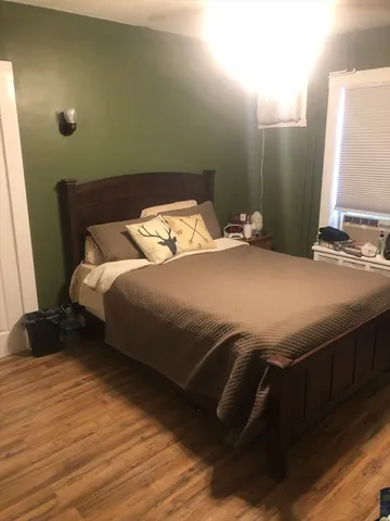 a bedroom with a bed and a mirror