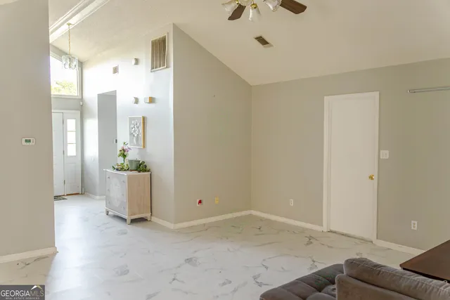 a view of a room with a sink and cabinets