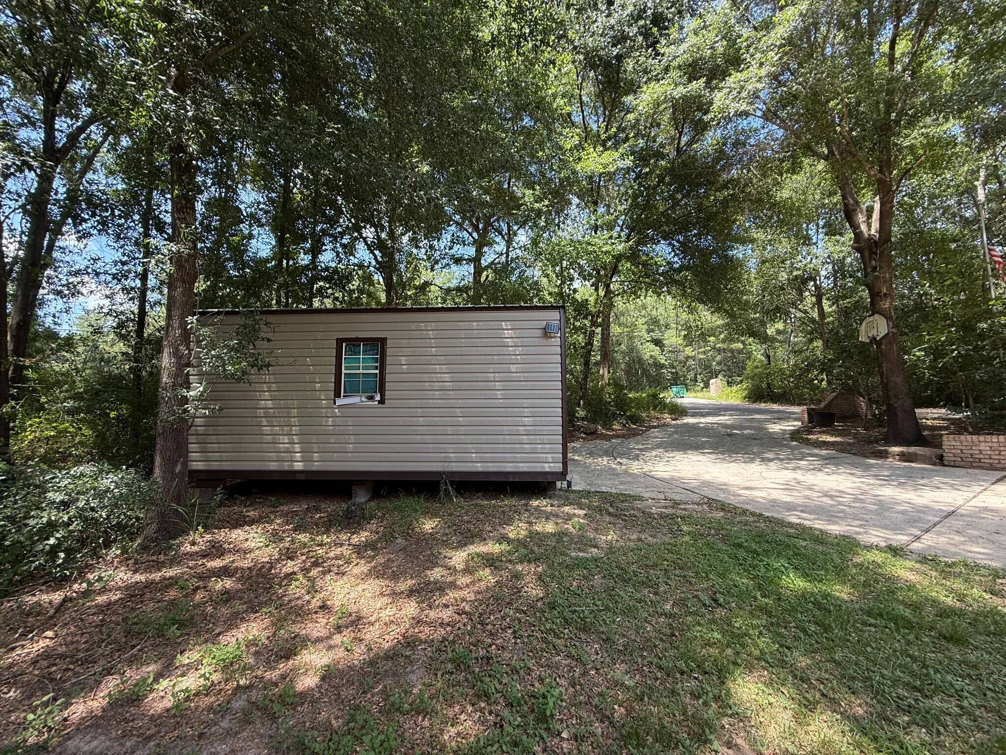 100 Overview Drive Crestview, FL 32539 - Photo 11 of 82 a view of a barn in the middle of a yard