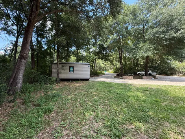 a view of a swimming pool and lounge chairs in the patio