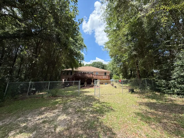 a view of a house with backyard and sitting area