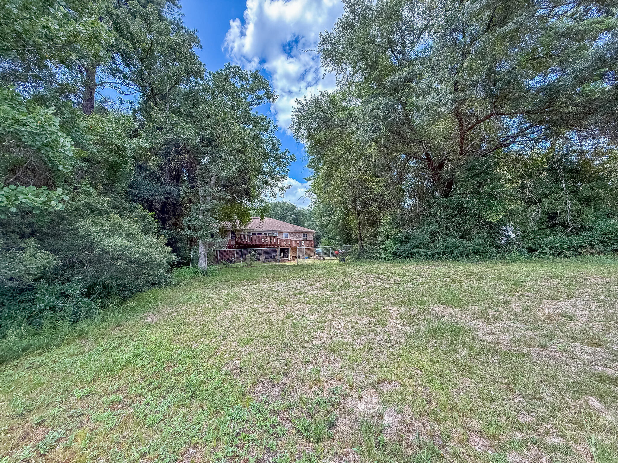 100 Overview Drive Crestview, FL 32539 - Photo 26 of 82 a backyard of a house with trees and outdoor space