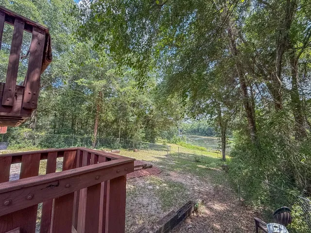 a bedroom with a bed furniture and a flat screen tv
