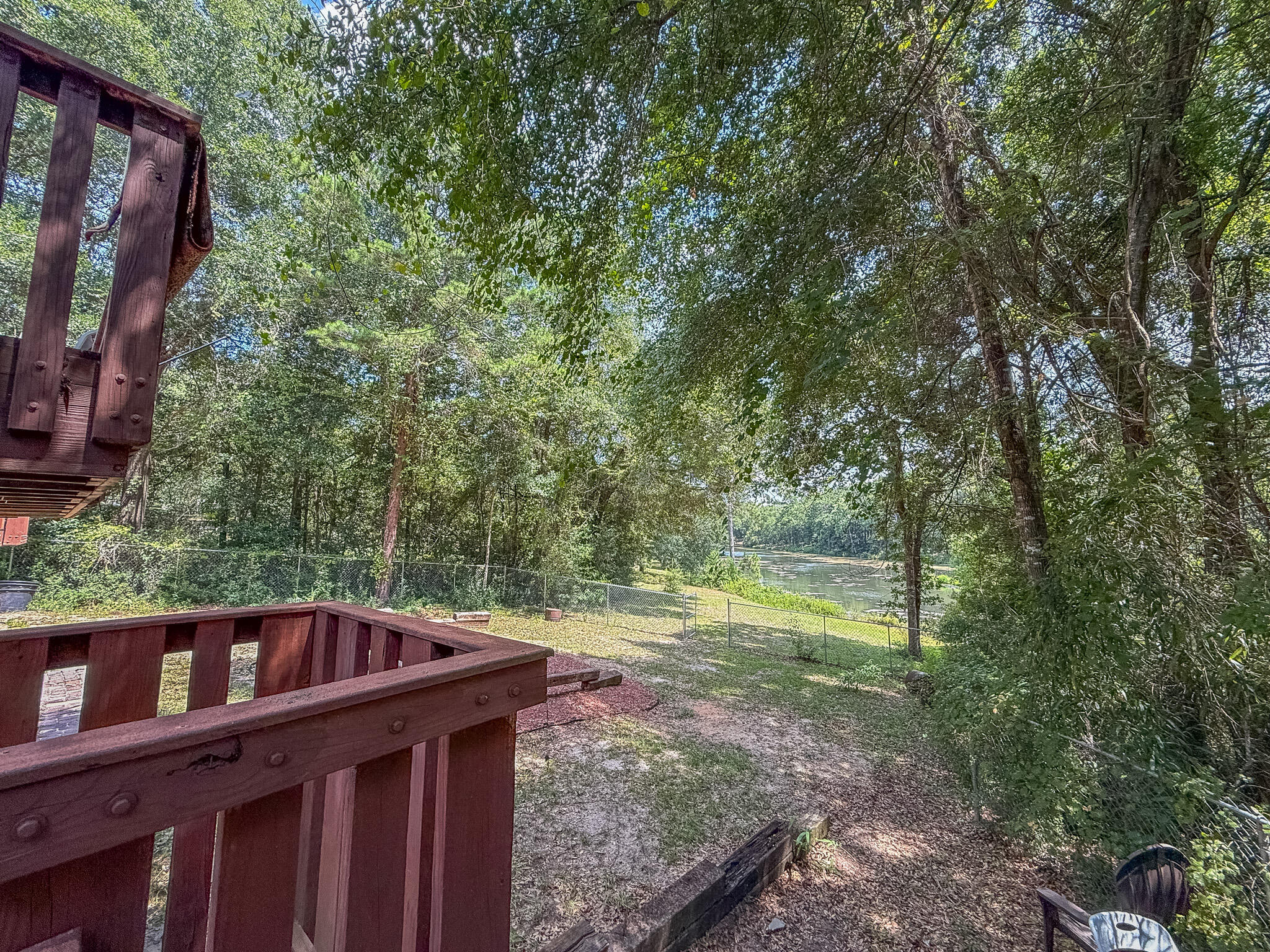 100 Overview Drive Crestview, FL 32539 - Photo 42 of 82 a backyard of a house with large trees and wooden fence