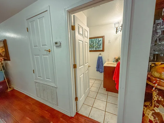 a view of a workspace with furniture and mirror
