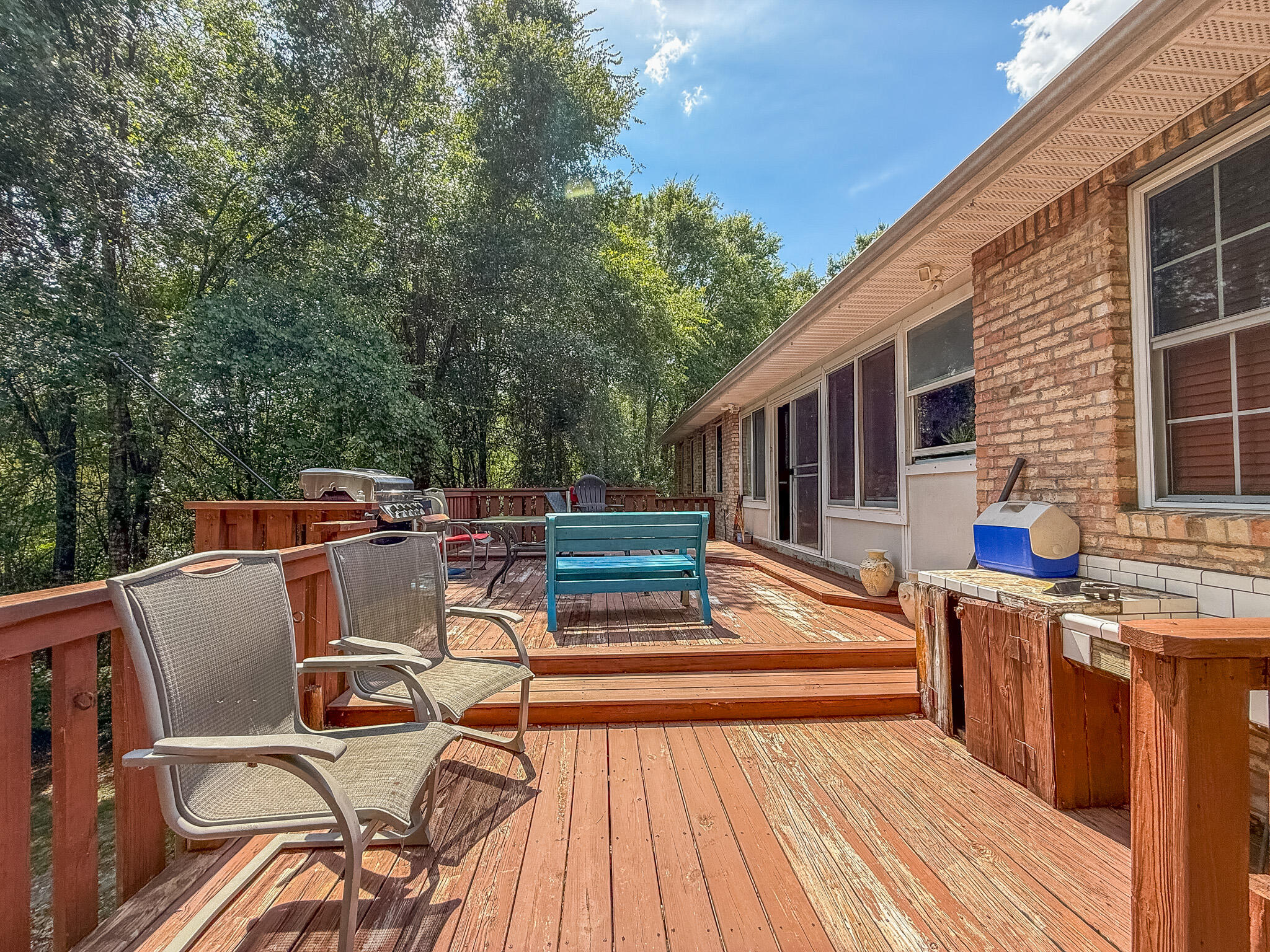 100 Overview Drive Crestview, FL 32539 - Photo 66 of 82 a view of a patio with table and chairs with wooden floor and fence