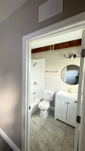 a bathroom with a toilet a sink and bathtub
