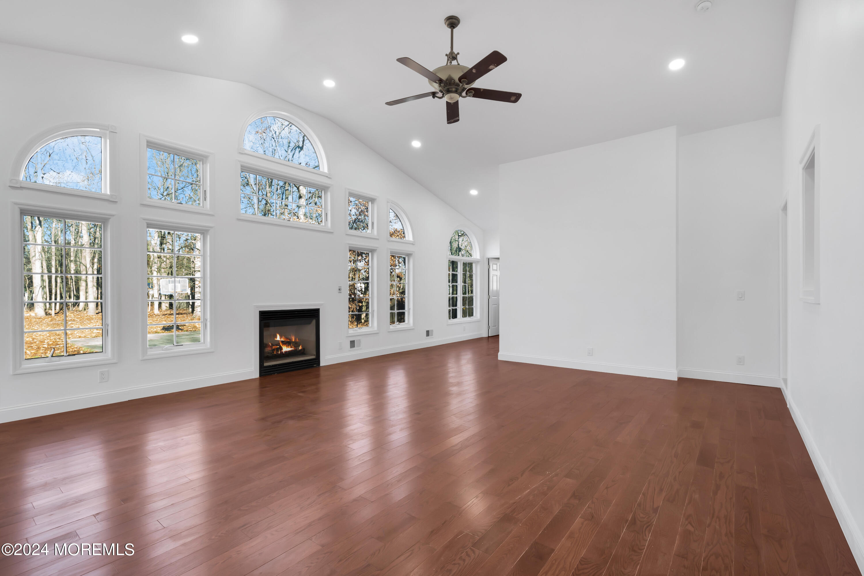 6 Afton Road Jackson, NJ 08527 - Photo 37 of 80 an empty room with windows fireplace and wooden floor