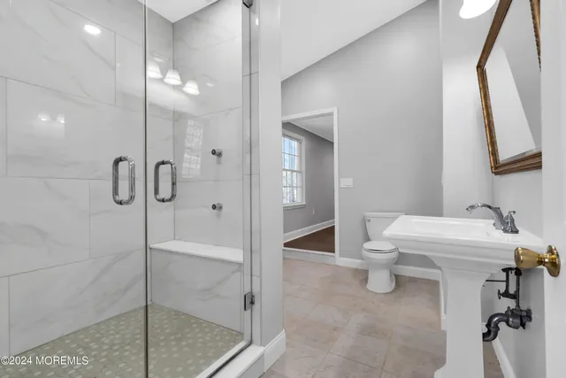 a view of a house with a yard and large tree