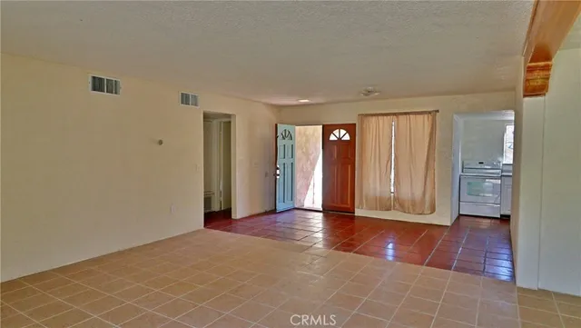 a view of an empty room with glass door