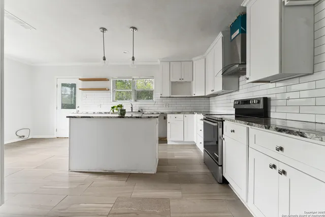 a kitchen with cabinets and white appliances
