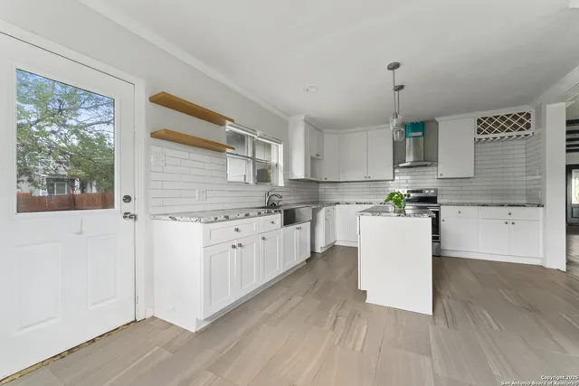 a kitchen with white cabinets and white appliances