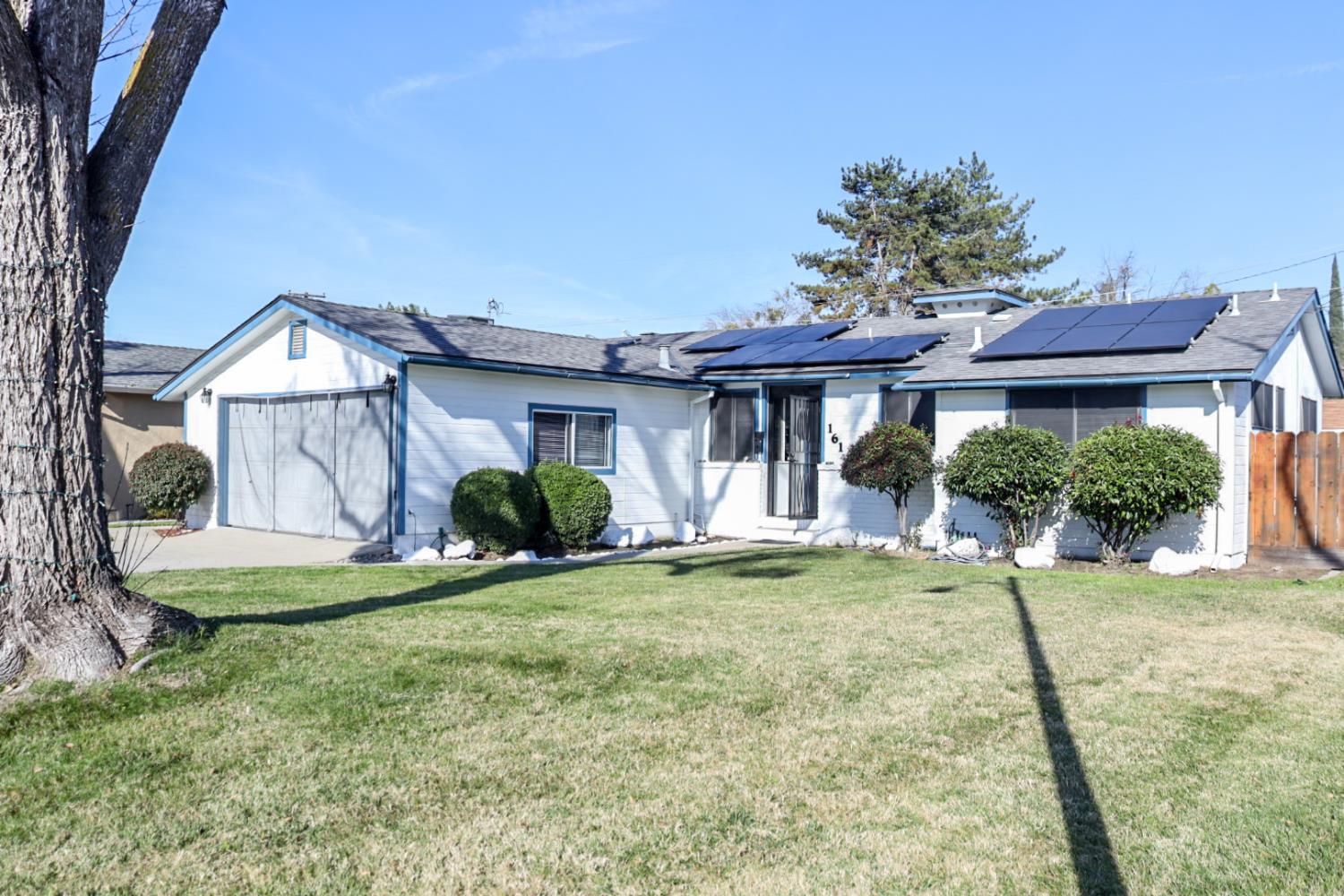 161 Ribier Avenue Modesto, CA 95350 - Photo 3 of 26 a front view of a house with a yard table and chairs