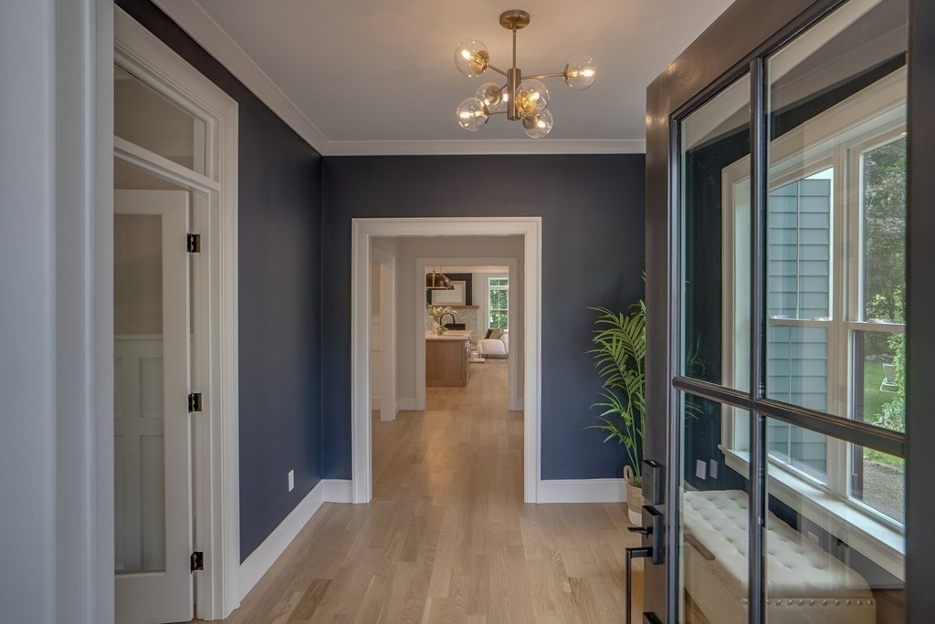 25 Webber Avenue Bedford, MA 01730 - Photo 15 of 42 a view of a hallway with wooden floor and a chandelier