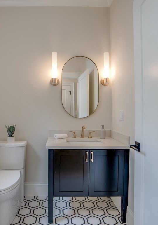 25 Webber Avenue Bedford, MA 01730 - Photo 16 of 42 a bathroom with a toilet sink and mirror