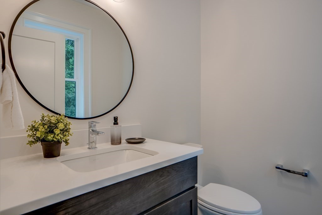 25 Webber Avenue Bedford, MA 01730 - Photo 20 of 42 a bathroom with a sink mirror and toilet