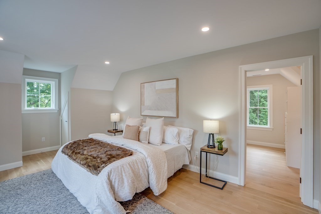 25 Webber Avenue Bedford, MA 01730 - Photo 23 of 42 a bedroom with a bed and wooden floor