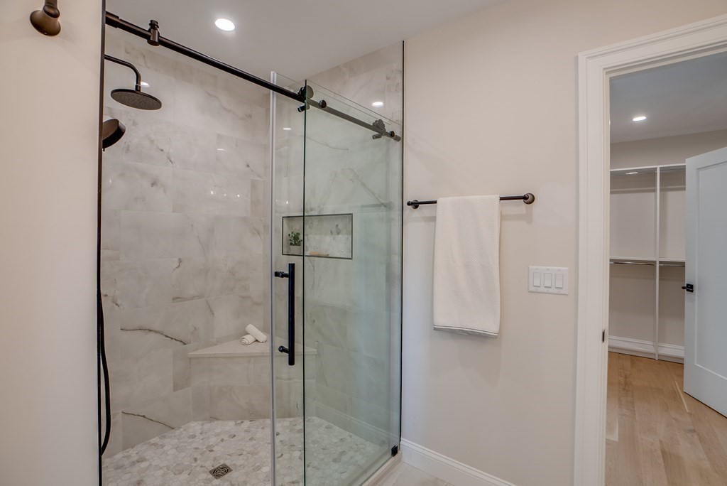 25 Webber Avenue Bedford, MA 01730 - Photo 25 of 42 a bathroom with a shower and a glass door