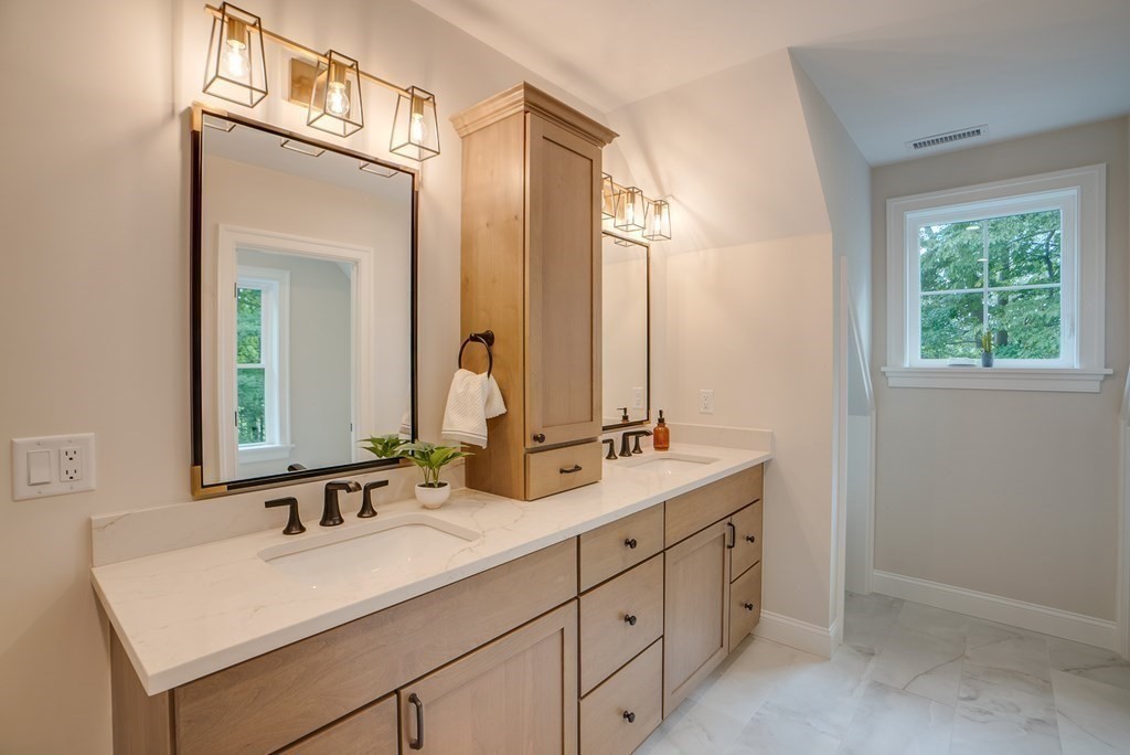 25 Webber Avenue Bedford, MA 01730 - Photo 26 of 42 a bathroom with a sink double vanity and a mirror