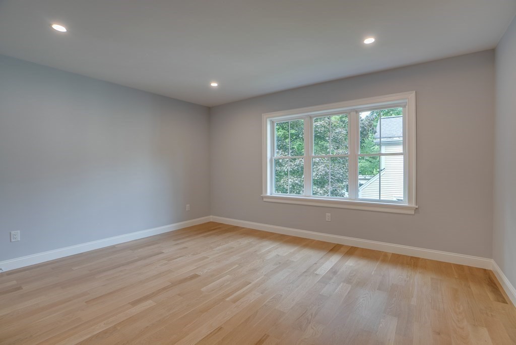 25 Webber Avenue Bedford, MA 01730 - Photo 27 of 42 an empty room with wooden floor and windows