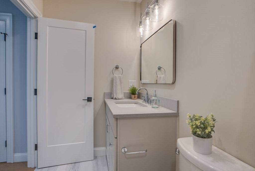 25 Webber Avenue Bedford, MA 01730 - Photo 29 of 42 a bathroom with a toilet sink and mirror