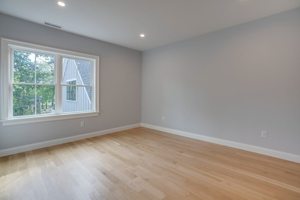 25 Webber Avenue Bedford, MA 01730 - Photo 30 of 42 a view of an empty room with wooden floor and a window