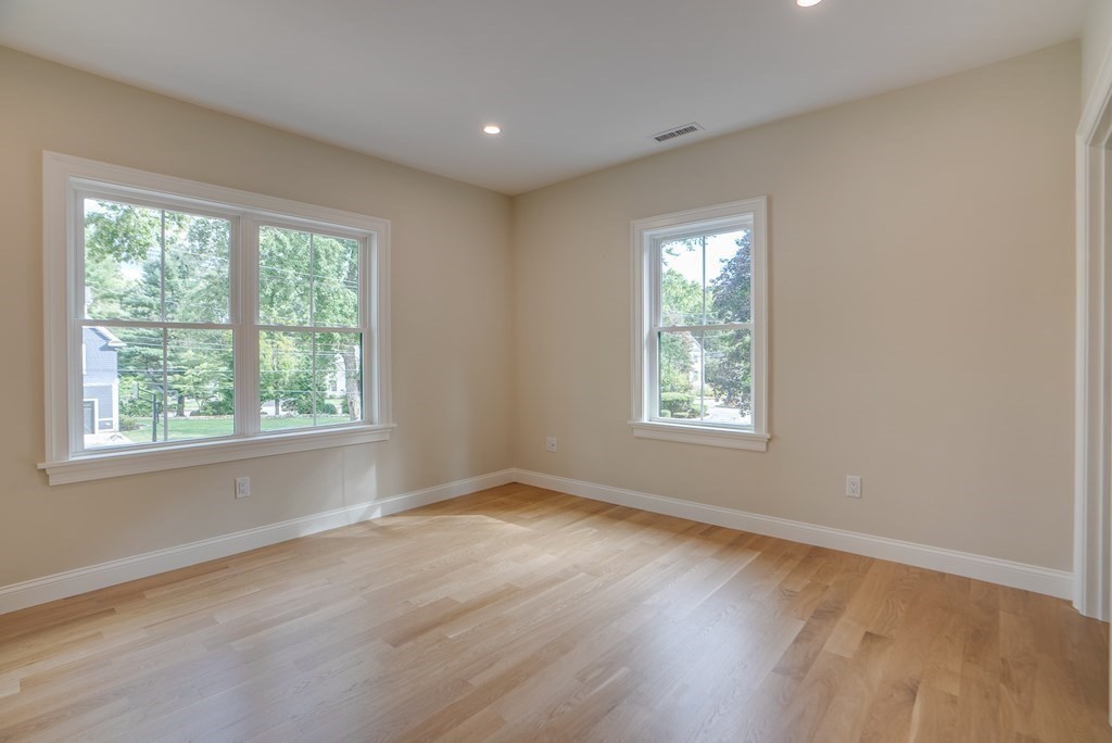 25 Webber Avenue Bedford, MA 01730 - Photo 34 of 42 a view of an empty room with wooden floor and a window