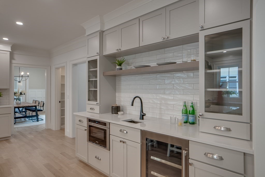 25 Webber Avenue Bedford, MA 01730 - Photo 5 of 42 a kitchen with stainless steel appliances a sink and cabinets