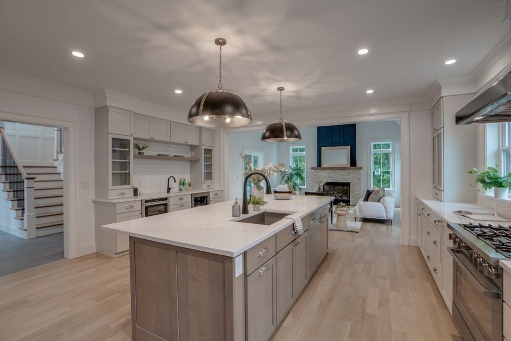25 Webber Avenue Bedford, MA 01730 - Photo 7 of 42 a kitchen with stainless steel appliances a sink a stove top oven a counter space and cabinets