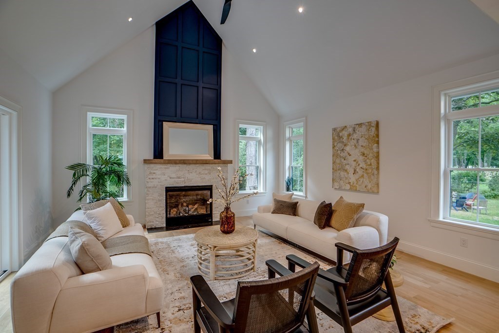 25 Webber Avenue Bedford, MA 01730 - Photo 9 of 42 a living room with furniture a fireplace and a window