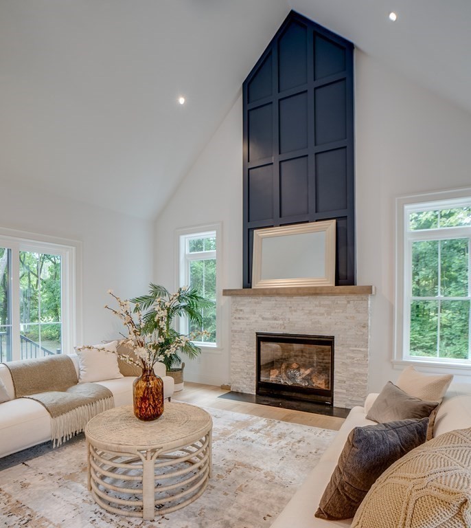 25 Webber Avenue Bedford, MA 01730 - Photo 10 of 42 a living room with furniture a window and a fireplace