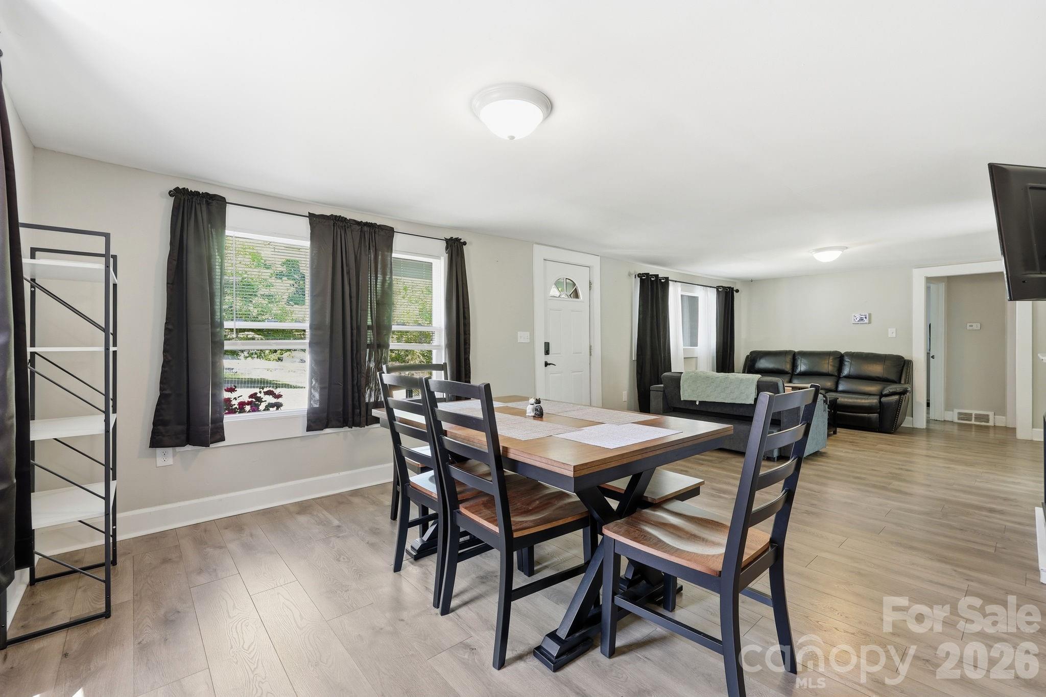 197 Mulberry Street Clyde, NC 28721 - Photo 7 of 31 a view of a dining room with furniture and wooden floor