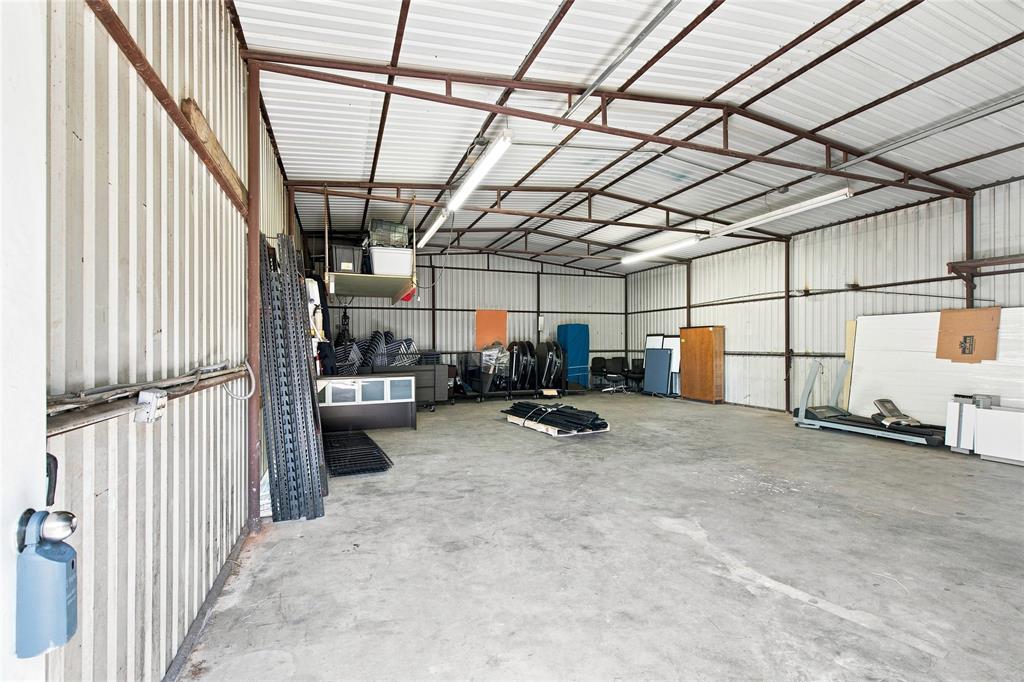 6800 Curtis Road Colleyville, TX 76034 - Photo 11 of 13 Spacious interior featuring a concrete floor, corrugated metal walls, exposed metal framing, and overhead fluorescent lighting