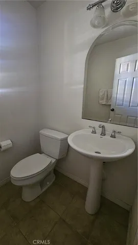 a white toilet sitting next to a bathroom sink